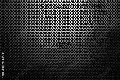 Black perforated metal texture, with many small holes and a gradient of light