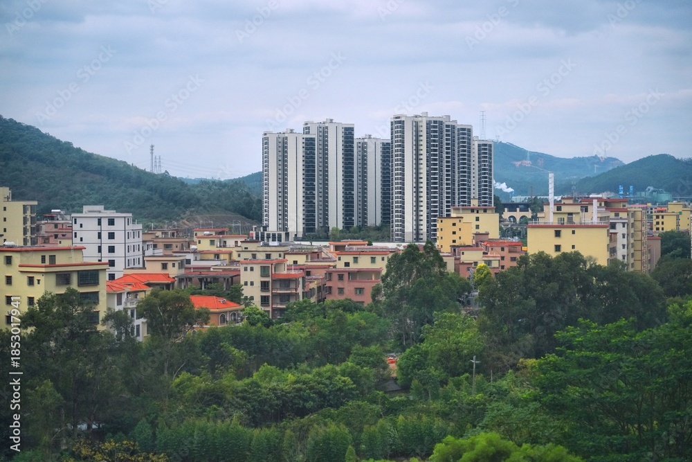 Fototapeta premium City residential architecture and green hills of Qingcheng District in Qingyuan, Guangdong region of China.
