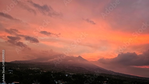 A scenic view of colorful sunset sky. Sunset in the mountains. serene Vibrant Sunset Over Silhouetted Mountains
