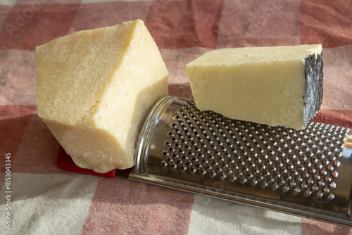 piece of parmesan and pecorino romano on rustic cloth with natural light