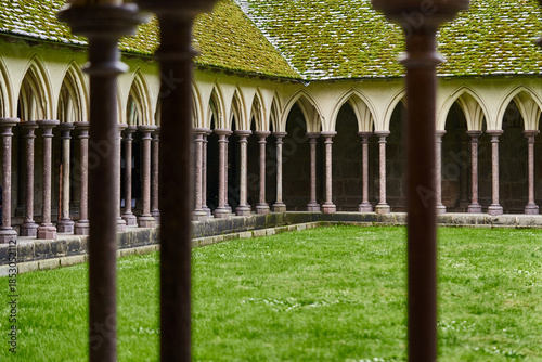 Historic Cloister Courtyard at Mont Saint-Michel Abbey Viewed Through Stone Columns, Normandy France