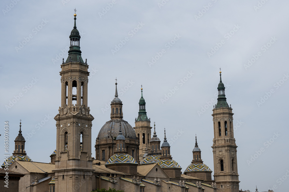 Obraz premium Historical architecture with towers and domes under cloudy sky