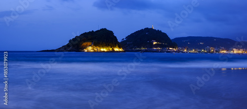 Santa Clara Island from Ondarreta Beach. La Concha Bay at dusk, city of Donostia - San Sebastian, Basque Country