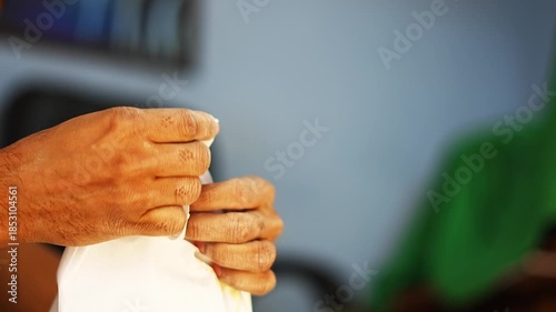 Close-up video of a man safely disposing used medical gloves into a paper bag after treatment, showing proper hygiene, waste disposal, and healthcare safety practices.