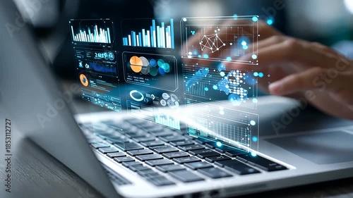 Person working on laptop with digital data and charts projected over the screen, analyzing business insights.