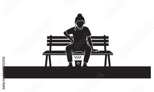 Woman sitting on a bench with portable heater on her lap