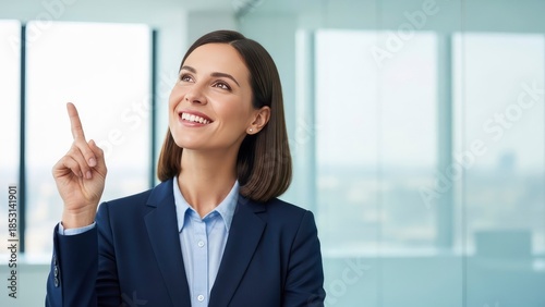 Businesswoman pointing upward in modern office