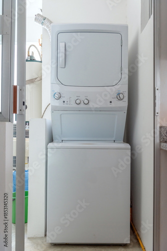 Stacked washer and dryer in apartment laundry area