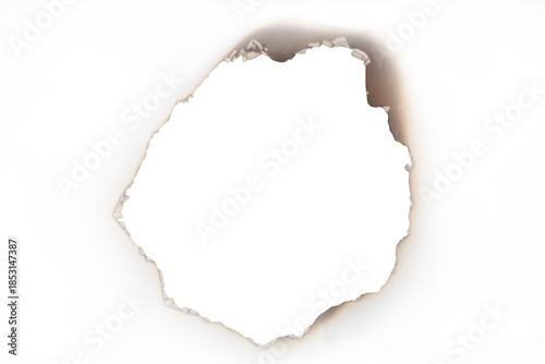 A close-up view of a burnt hole with distinctly charred and smoky edges on a light background isolated on transparent background