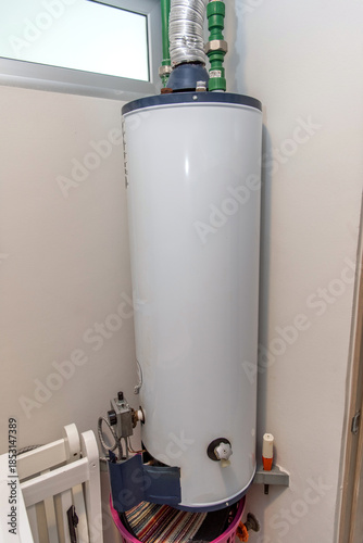 Residential gas water heater with pipe connections installed