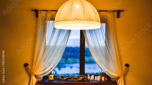 Cozy window view at twilight with a large lampshade