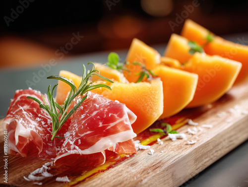 Slices of orange melon with Parma ham on the side.