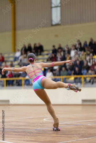 Artistic roller skater balancing on one leg performing routine
