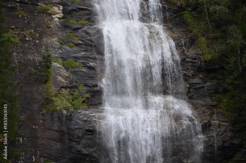 Obraz premium Waterfall in the Austrian Alps. Mountain and forest landscape.