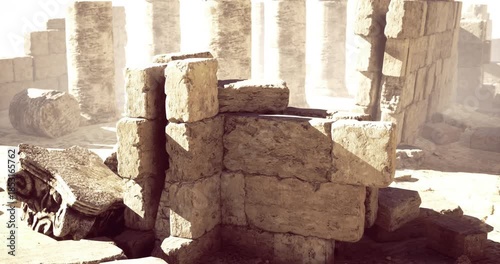 Dust fills the air around weathered stone ruins with tall columns illuminating the past. The setting hints at a longstanding civilizations architectural achievements.