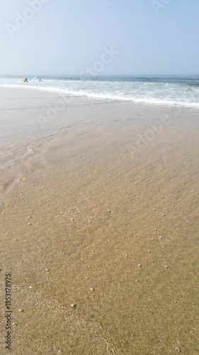 Gentle Wave Washing Over a Sandy Beach
