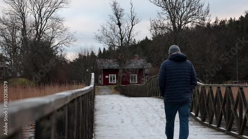 Stockholm, Sweden A man walks on a icy path in the winter countryside.