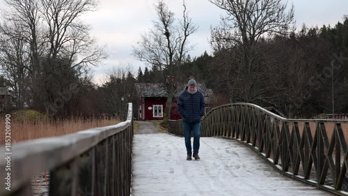 Stockholm, Sweden A man walks on a icy path in the winter countryside.
