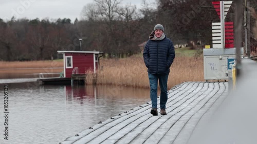 Stockholm, Sweden A man walks on a icy path in the winter countryside.