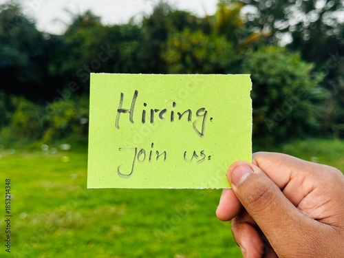 We are hiring trendy card post holding by hand, Join our team recruiting message, Drop your CV sticky note message, Vacancy here image