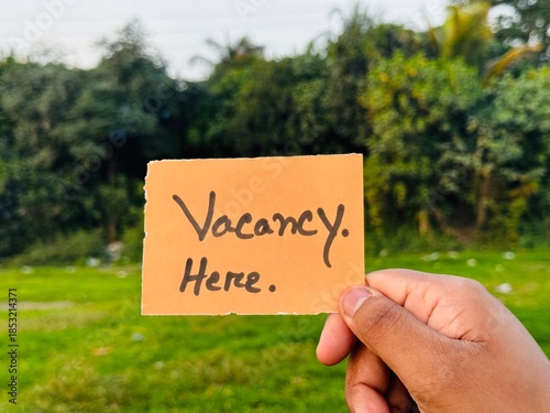 We are hiring trendy card post holding by hand, Join our team recruiting message, Drop your CV sticky note message, Vacancy here image