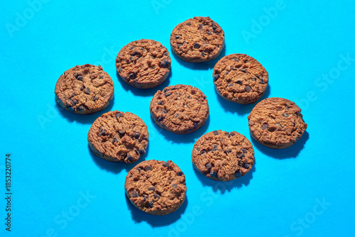 Cookies Arranged on a Blue Surface With Chocolate Chips Visible