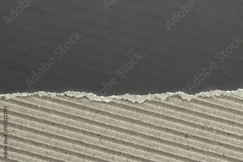 Ripped paper frame revealing dark background with textured edges and copy space.