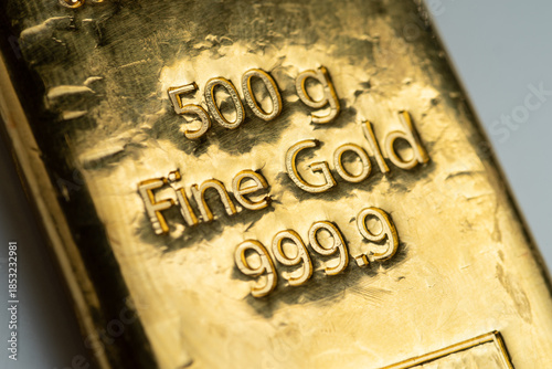 The surface of cast gold bar weighing 500 grams. The texture of the surface of the gold ingot. Selective focus.