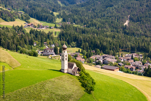 Tableau sur toile Chiesa di San Valentino within the Seiser Alm plateau, Dolomites, aerial view