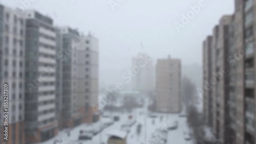 Snowfall covered the city with a white shroud, blurring the cityscape