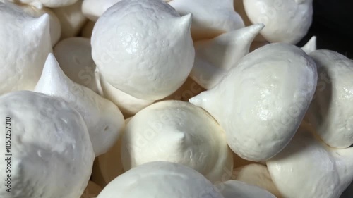 pile of white sweet meringues on a rotating plate 