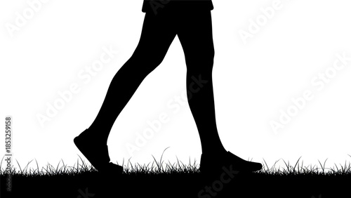 Silhouette of walking person on grass in black and white against white background