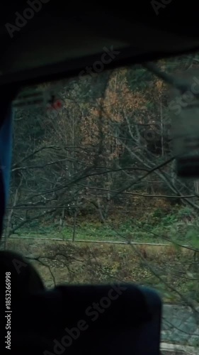 A beautiful view of nature from a train window during a journey. A railway in the mountains.