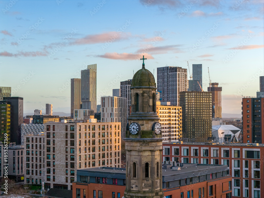 Obraz premium St. Phillips Clocktower set against Manchester's skyscrapers