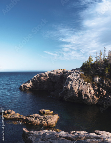 Fotografija Rocky Coastal Cliff Above Ocean Under Blue Sky - Cape Breton Highlands National