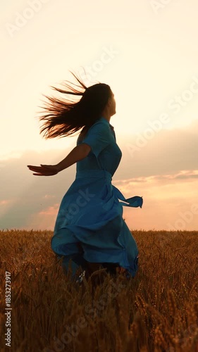 Beautiful Girl, happy life. Free woman runs ears wheat. Young girl joyfully runs through wheat field at sunset. Woman dream in nature. Female farmer, arms outstretched, runs through wheat field. Sun
