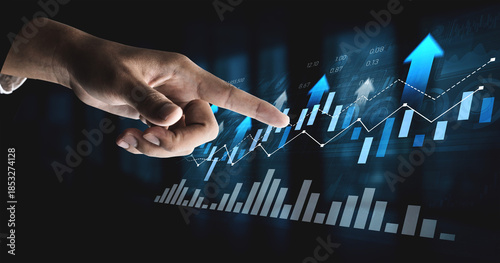 Tableau sur toile A close-up of a hand pointing at evolving financial graphs displaying growth and progress in business, representing success and data analysis in a digital environment