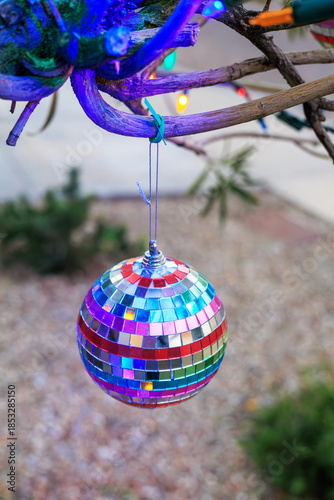 Rainbow-mirrored Disco Ball Ornament Hanging from a Tree above the Ground, Shallow DOF