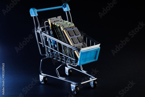 Ram ddr memory modules for laptop in toy shopping cart on black background