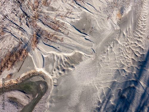 Fotografija White Salt Flat Landscape With Textured Ridges and Mineral Deposits in BC, Canad