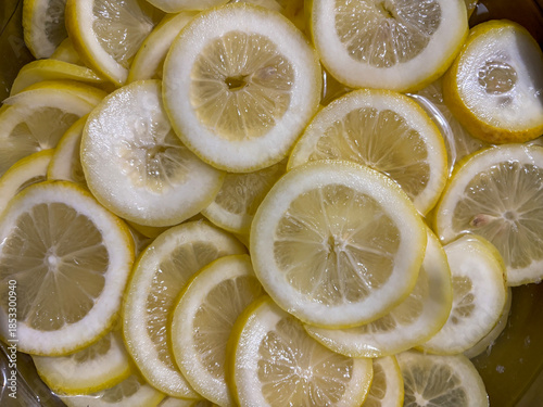 Overlapping slices of fresh lemon soaking in water