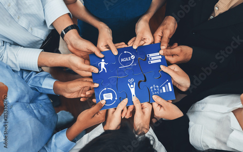 Photography Diverse corporate officer workers collaborate in office, connecting puzzle pieces to represent partnership and teamwork