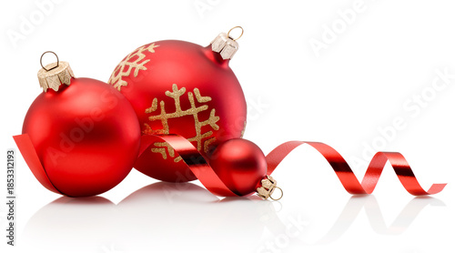 Three red Christmas decoration baubles and curling paper ribbon isolated on white background
