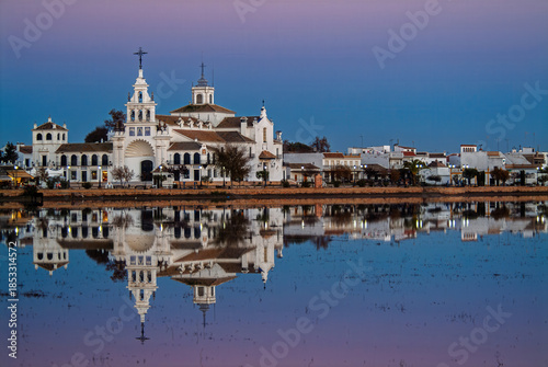 Hermitage of El Rocio reflected in Doñana wetlands at dusk