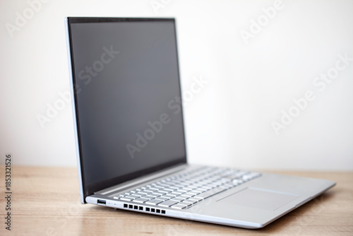 Close-up of gray laptop on a wooden table