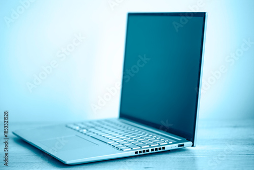 Close-up of gray laptop on a wooden table