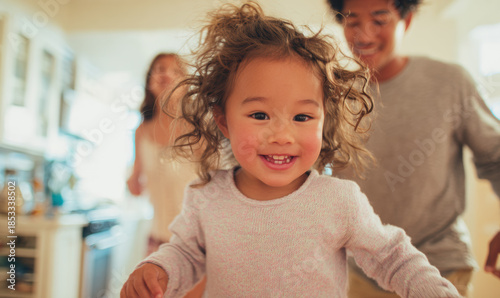 Multicultural children move energetically through a home while adults remain in the background during an ordinary day.