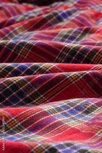 Gentle waves of red tartan fabric material