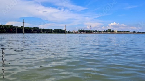 Wallpaper Mural A calm summer day reveals a blue ocean landscape where a boat and ship sail toward the horizon under a cloudy sky with gentle waves Torontodigital.ca