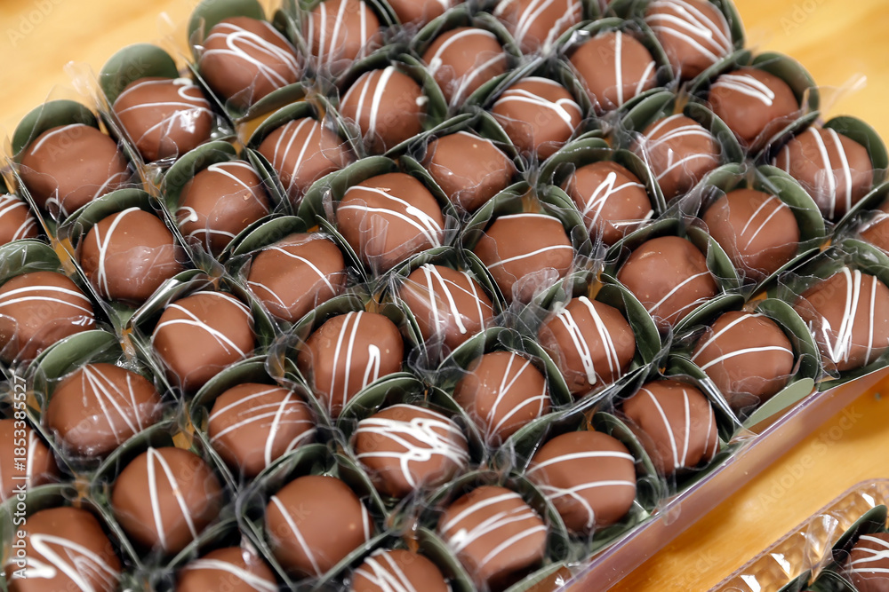 Fototapeta premium Mini Milk Chocolate Truffles with White Drizzle for Festive Events